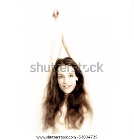 Pretty woman with long curly hair, hands over the head