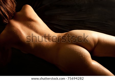 stock photo Beautiful back of nude young woman with wet body lying on 