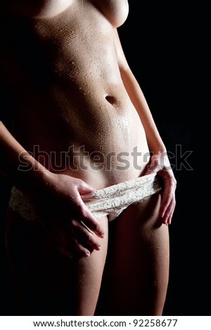stock photo Young woman taking off beautiful white panties in front of 
