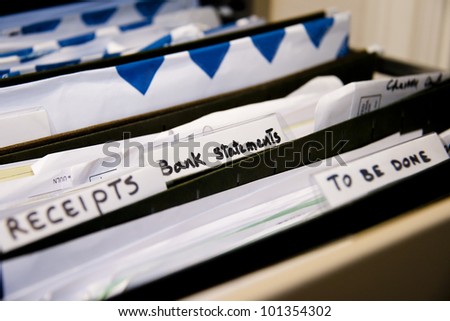 Close-up of an office shelves full of different files, focus on Bank Statements