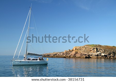 Yacht by the rocky coast