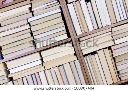 Old retro books on a wooden shelf  front view. Mass production, selective focus.