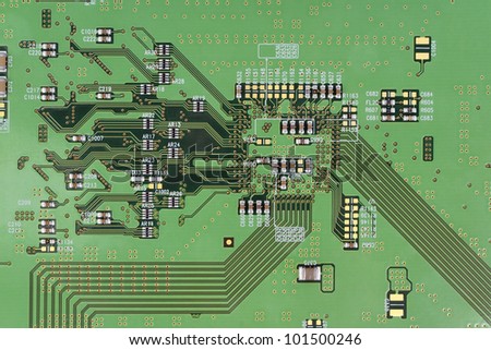 The modern printed-circuit board with electronic components macro background. Mass production.  Logos and trademarks  removed. There are only standard positional notation  and components values??.