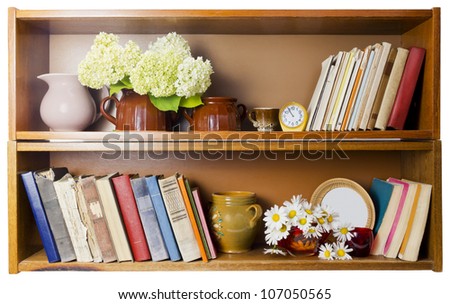 Rural village bookshelf with old broken  books, ceramic pots, clocks and daisies flowers. Isolated. Front view