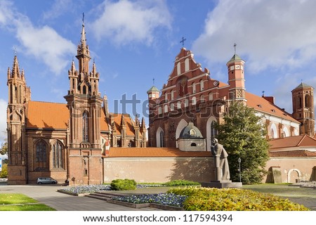 Ancient public domain old Roman Catholic Church of St. Anne in  the capital of Lithuania - Vilnius town. Vivid bright sunny autumn day. Soft art focus