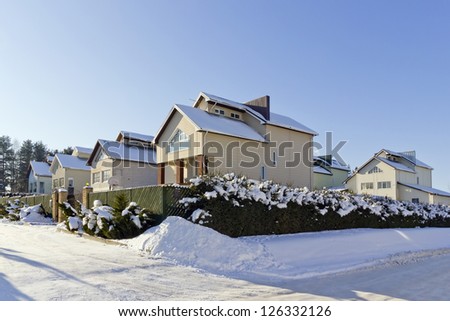 Modern European mass production  rural building village landscape, bright solar winter day