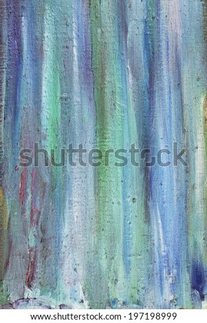 Strips of blue and green oil paint on a canvas are made a wide brush. Abstract background