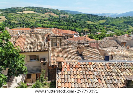 Typical landscape of the southern Italy. Tile roofs, mountains, olive gardens and hot sky