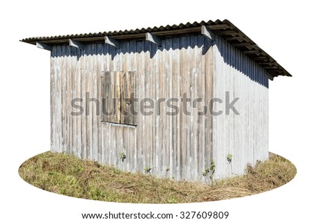 Rustic style old  shed was painted with blue. Under the influence of the sun and snow paint peeled off and grew old. Sunny autumn day.  Isolated