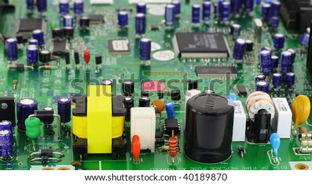 The modern printed-circuit board with various electronic components. In the foreground power supply components. Selective focus.