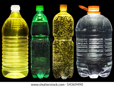 Set of plastic bottles with lemonade, oil and clear water. Isolated on black.