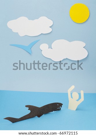 Children\'s collage from a paper with rough surface. The shark attacks the person. Help  request concept