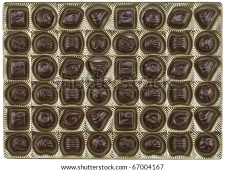 Chocolates with a various stuffing in the golden cartridge background. Mass production