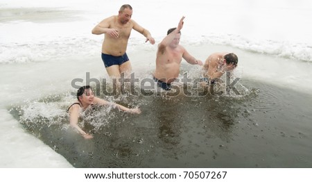 VILNIUS, LITHUANIA - FEBRUARY 5: Fans of winter swimming take a bath in some ice water on February 5, 2011 in Vilnius, Lithuania.