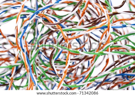 White,  blue, orange, green and brown wires from computer internet cables macro background. Selective focus