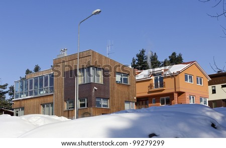 Modern European mass rural building village blocked by snow, solar winter day