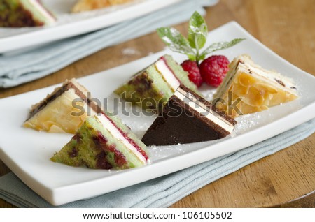 Selection of mini dessert sandwiches decorated with mint and raspberries