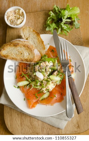 Smoked salmon salad with crab dressing and rocket with toast