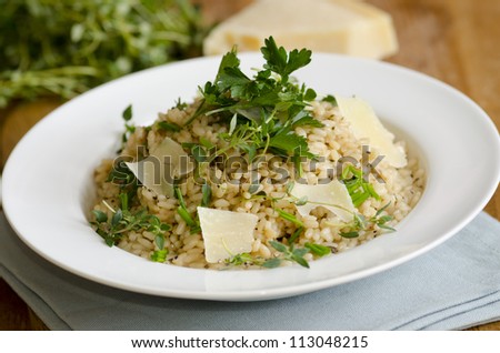 Risotto topped with shaved Parmesan, parsley, chives and thyme