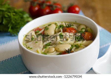 Chicken, pasta and butter bean soup in a bowl