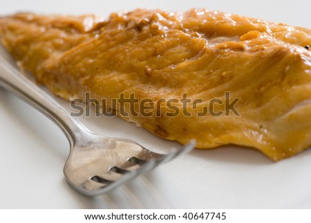 Smoked mackerel fillet with fork on white background