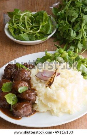 Meatballs with mashed potato and edamame and pea salad