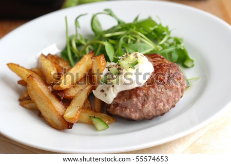 Burger with potato chips and salad