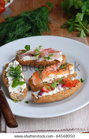 Toasts topped with creamy cheese, smoked salmon and pancetta