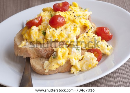 Toast with scrambled eggs and cherry tomatoes