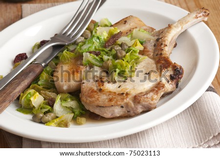 Pork chop with chard, raisins and green sauce