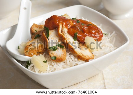 Chicken breast with coriander and pineapple rice in a bowl