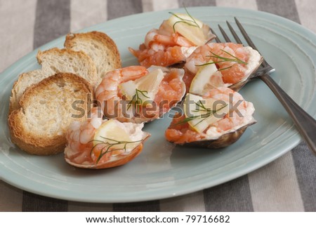 Scallop shells with prawns, king prawns and smoked salmon with toasted bread