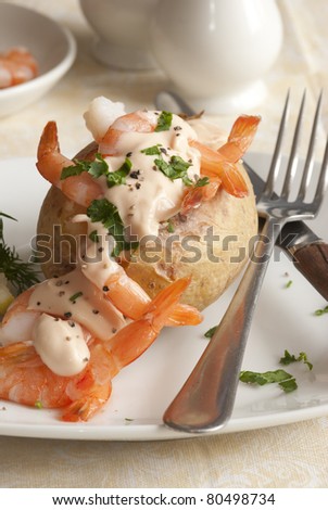 Jacket potato filled with prawn cocktail and herbs