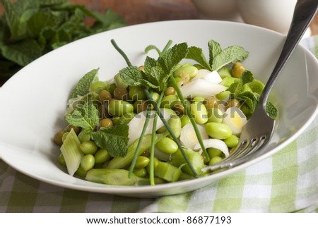 Broad bean, pea and spring onion salad topped with chives and mint