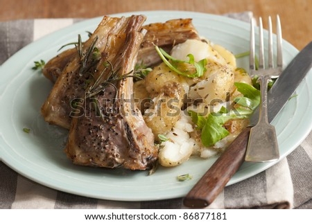Rosemary and garlic lamb cutlets with crushed new potatoes and rocket