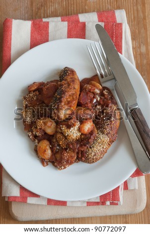 Grilled chorizo sausages with butter beans on a plate