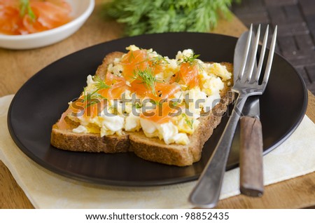 Toasted bread topped with smoked salmon and scrambled eggs