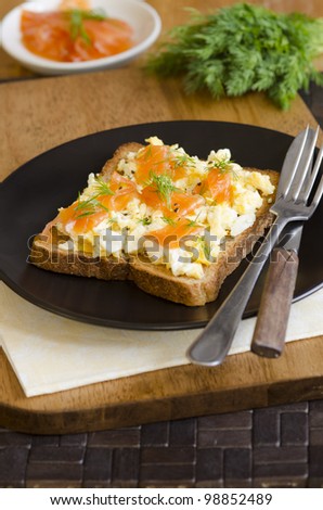 Toasted bread topped with smoked salmon and scrambled eggs