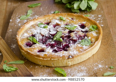 Sour cherry and almond frangipane in pastry decorated with flaked almonds