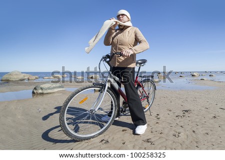 Woman and cycle at sea