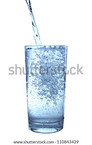 Glass of pouring water isolated on white .