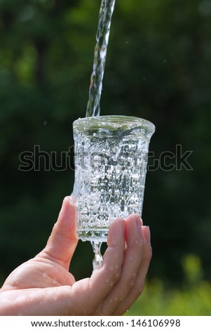 Glass of water in hand.
