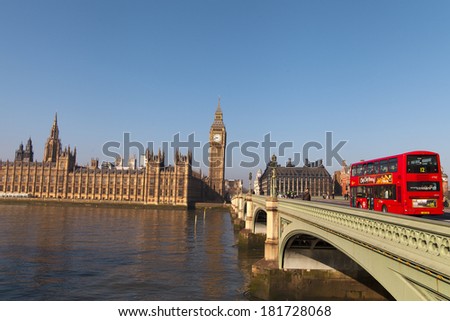 LONDON - MARCH 9. Iconic London bus crossing Westminster Bridge in the United Kingdom March 9, 2014 in London, England.