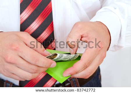 Hands and money in envelope.