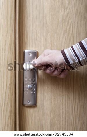 Hand opening the door.