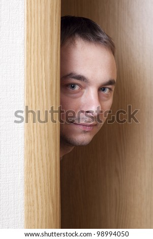 Man looking behind doors.