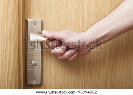 Man`s hand opening door.