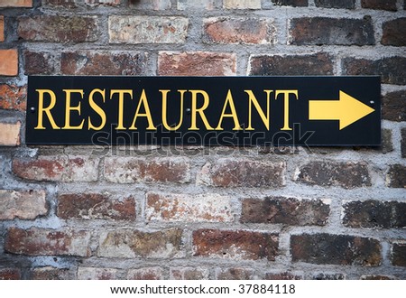 A sign showing the direction to a restaurant in Belfast.