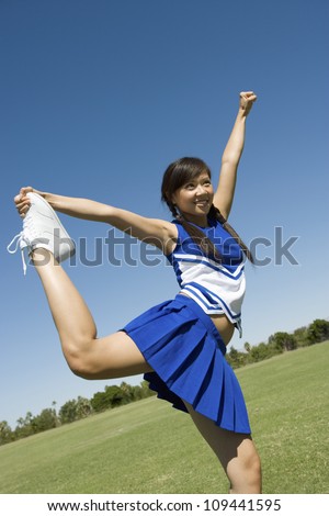 Young cheerleader performing on field