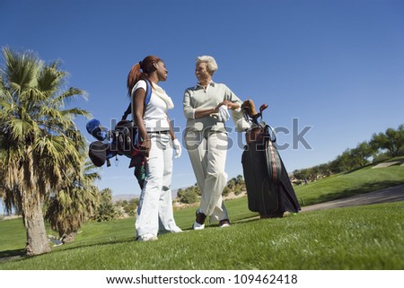 Full length of African American women chatting at golf course
